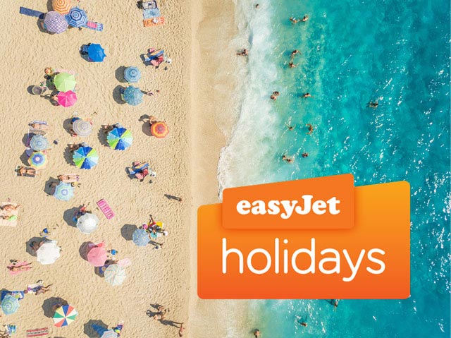 An aerial view showing people sunbathing and swimming along a sandy beach, with the easyJet holidays logo overlaid.